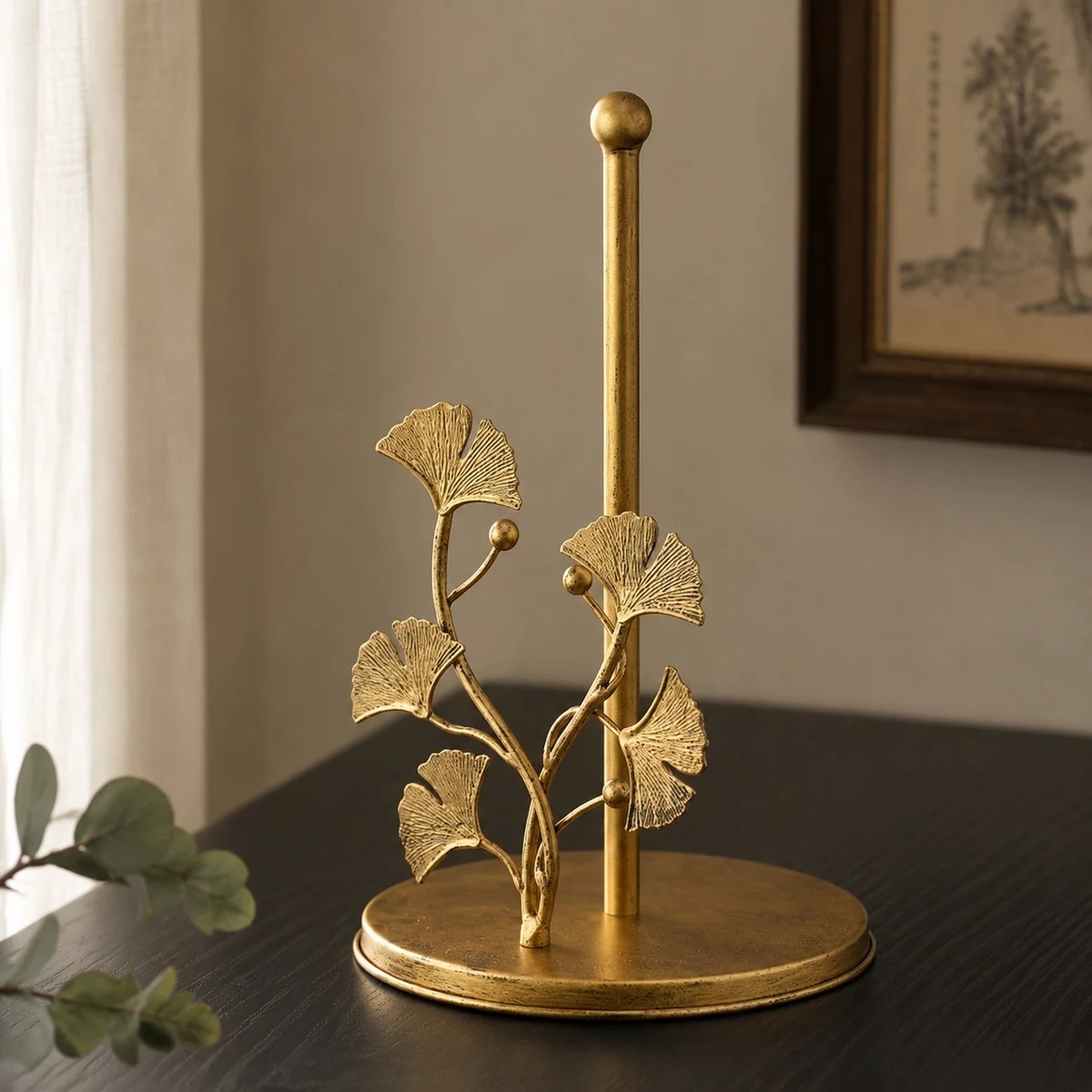 Forma brass ginkgo decorative tissue holder on a warm tabletop