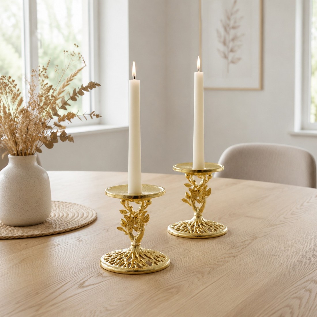 Two Aura gold candlesticks styled together on a dining table