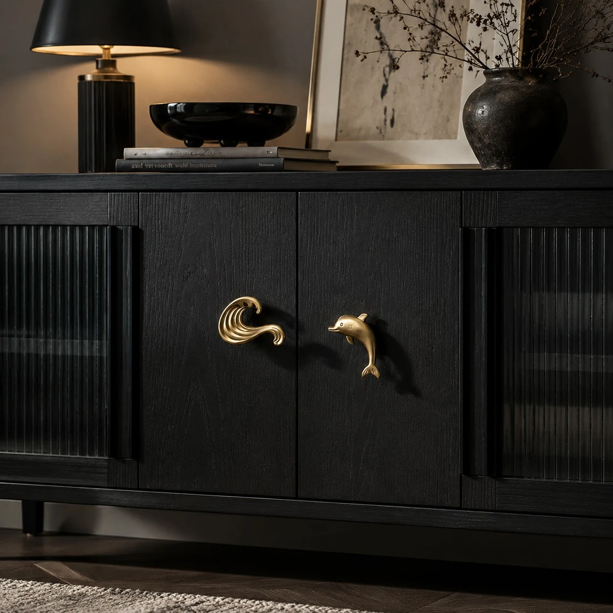 Totem dolphin and wave cabinet handles on a black sideboard