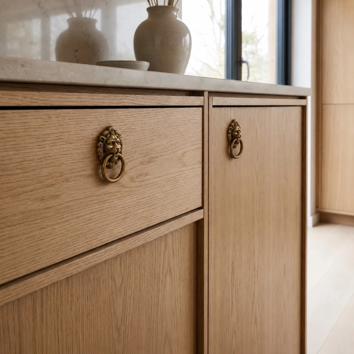 Totem lion head cabinet handles installed on wood cabinet doors