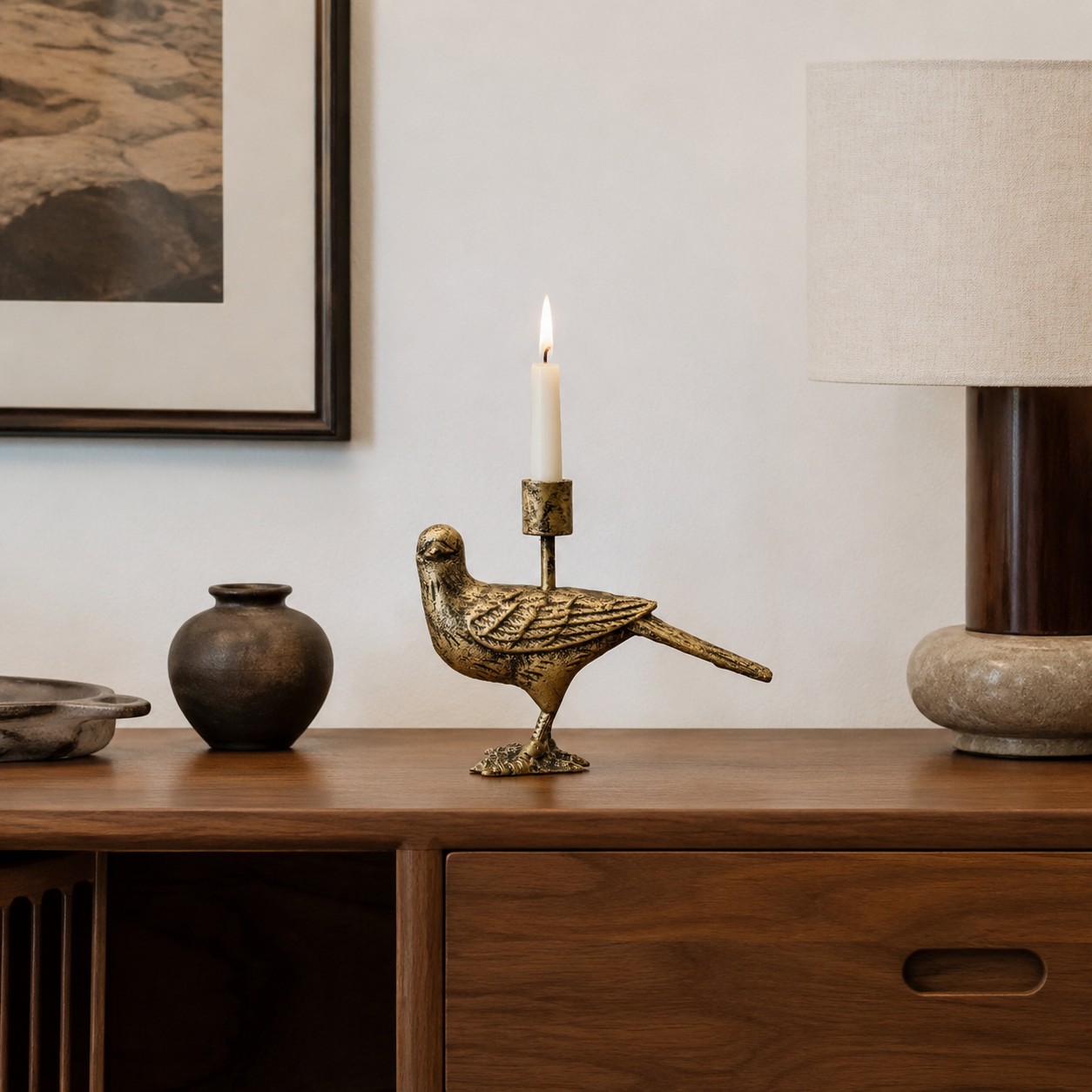 Aura long-tailed bird candlestick in a warm interior scene