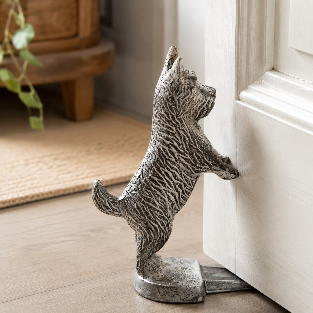 Guardian white cast iron dog door stopper holding a door open