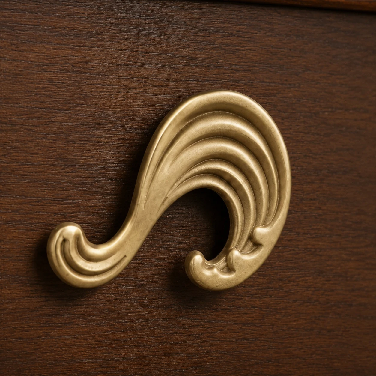 Natural brass Wave cabinet knob close-up showing sculpted ridges
