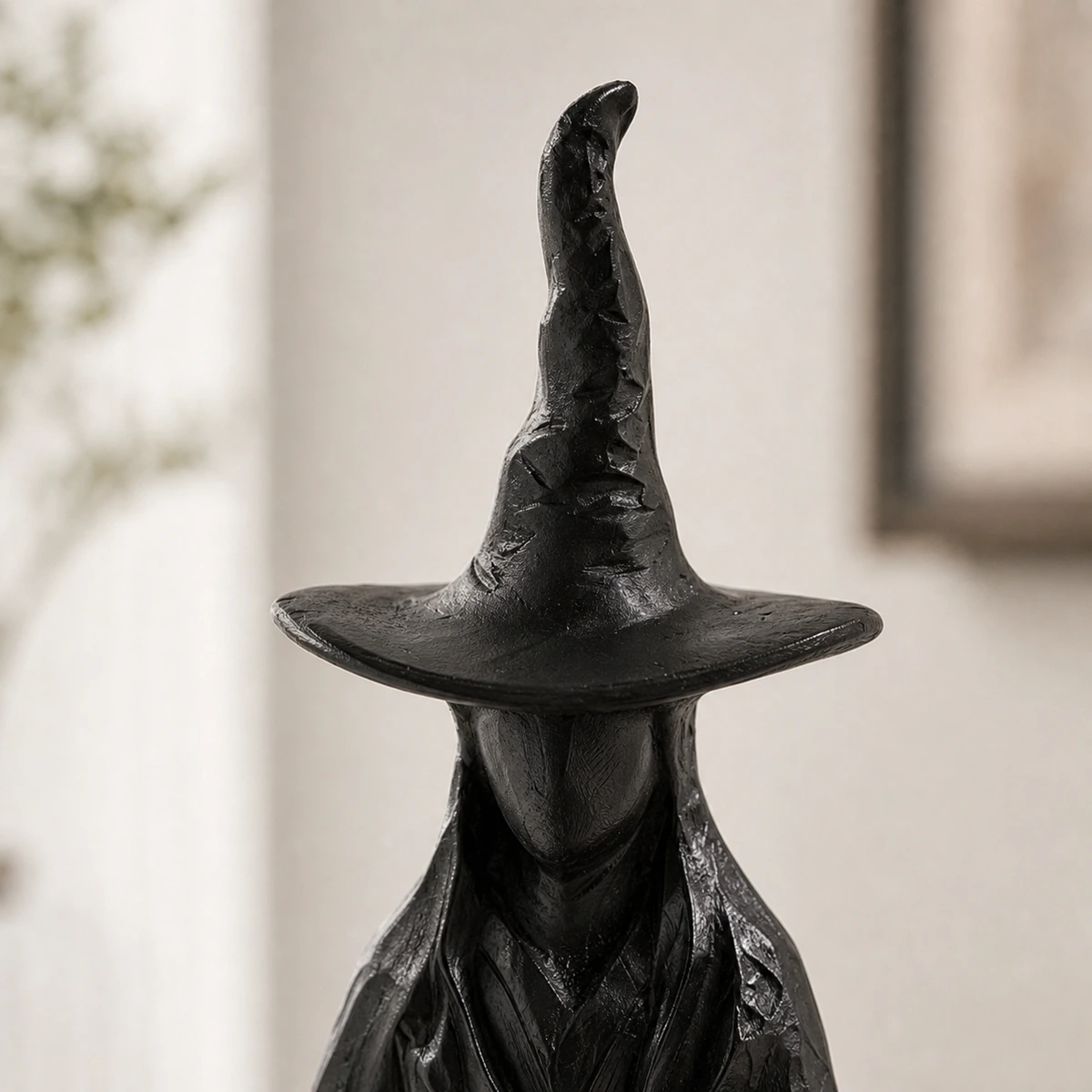 Close-up of the pointed hat and brim on the sculptural candlestick