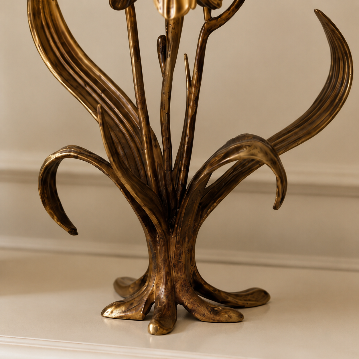 Sculptural base and sweeping leaf detail of the Aura Iris candle holder