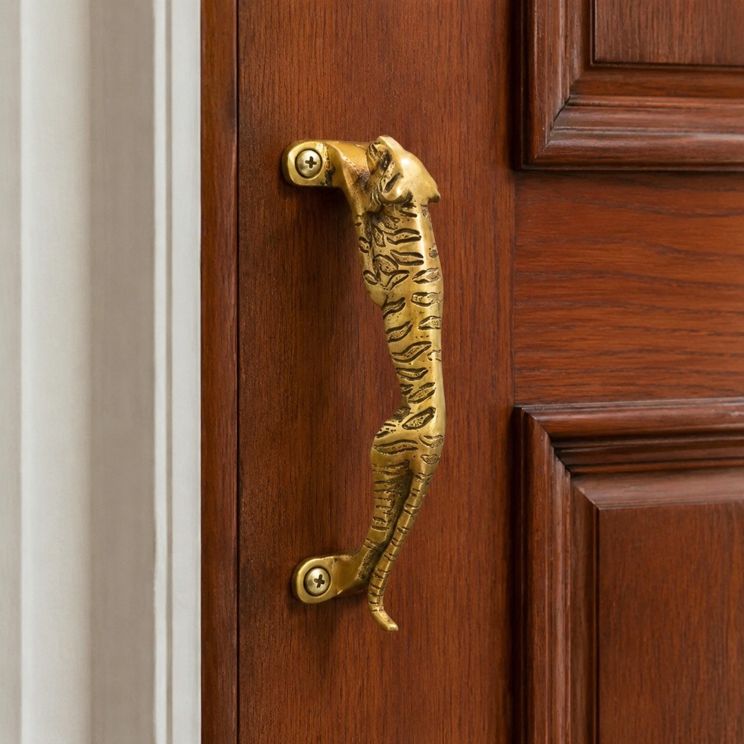 Totem Leopard A brass copper cabinet handle on a wood cabinet door