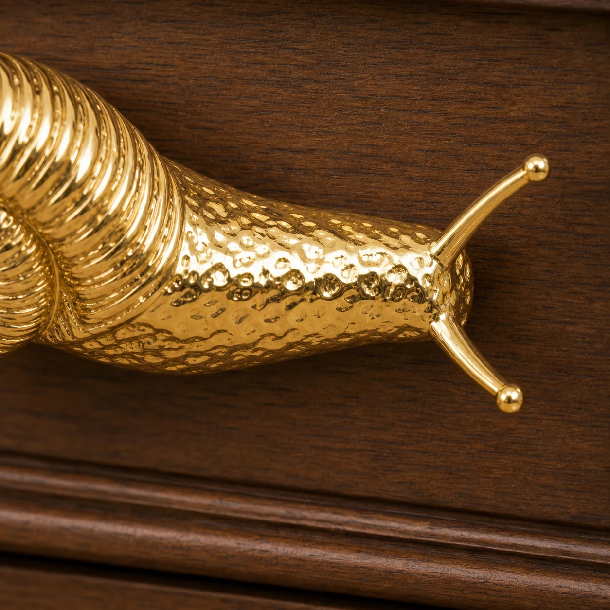 Close-up of hammered brass texture along the snail handle body