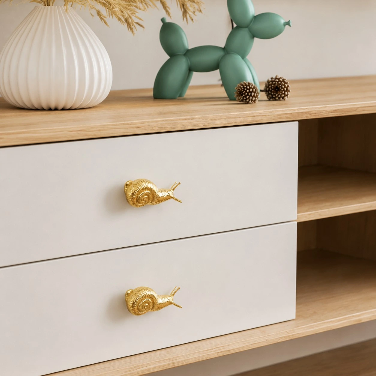 Totem brass snail cabinet handle shown in a styled cabinet scene