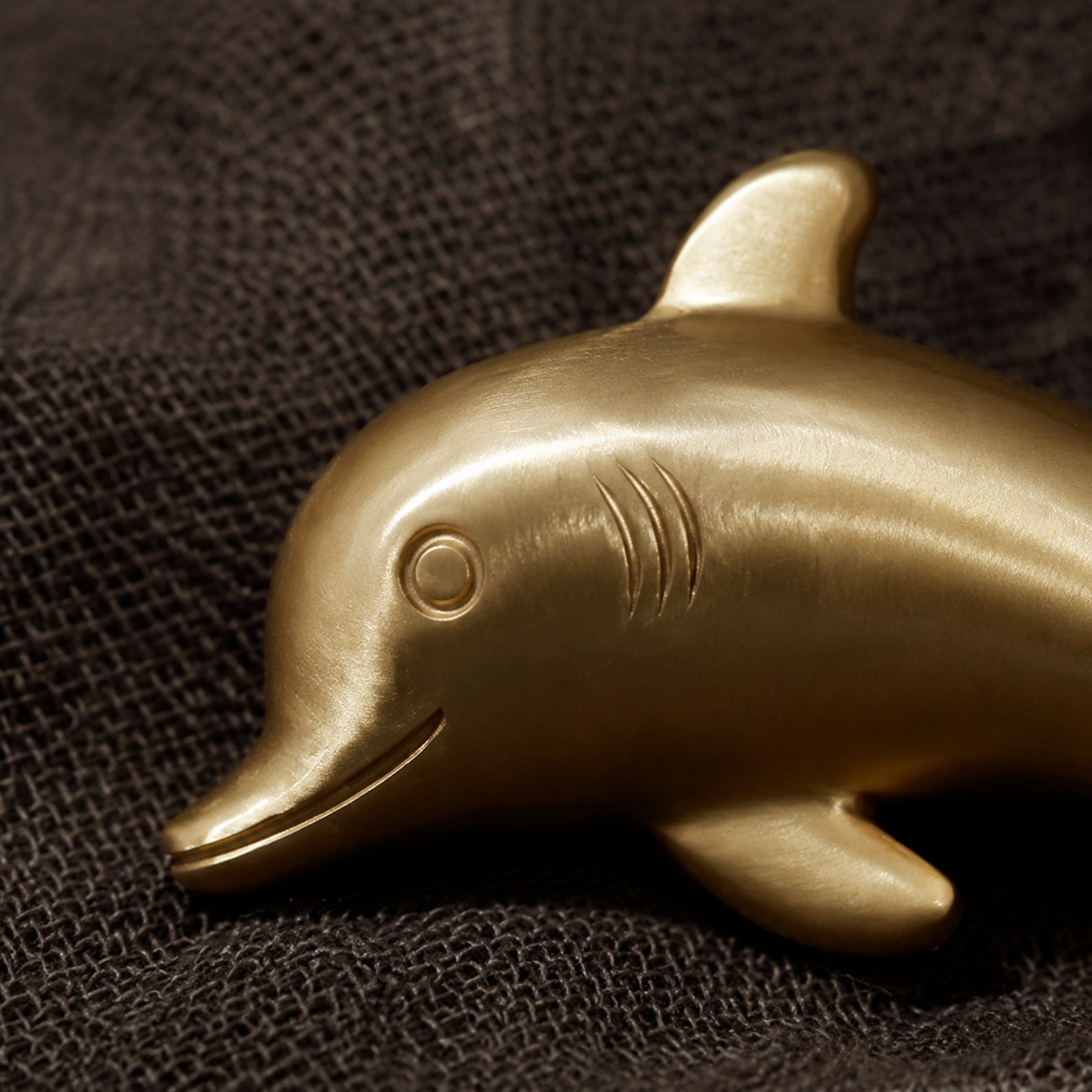 Detailed dolphin face and gill grooves on the Totem handle