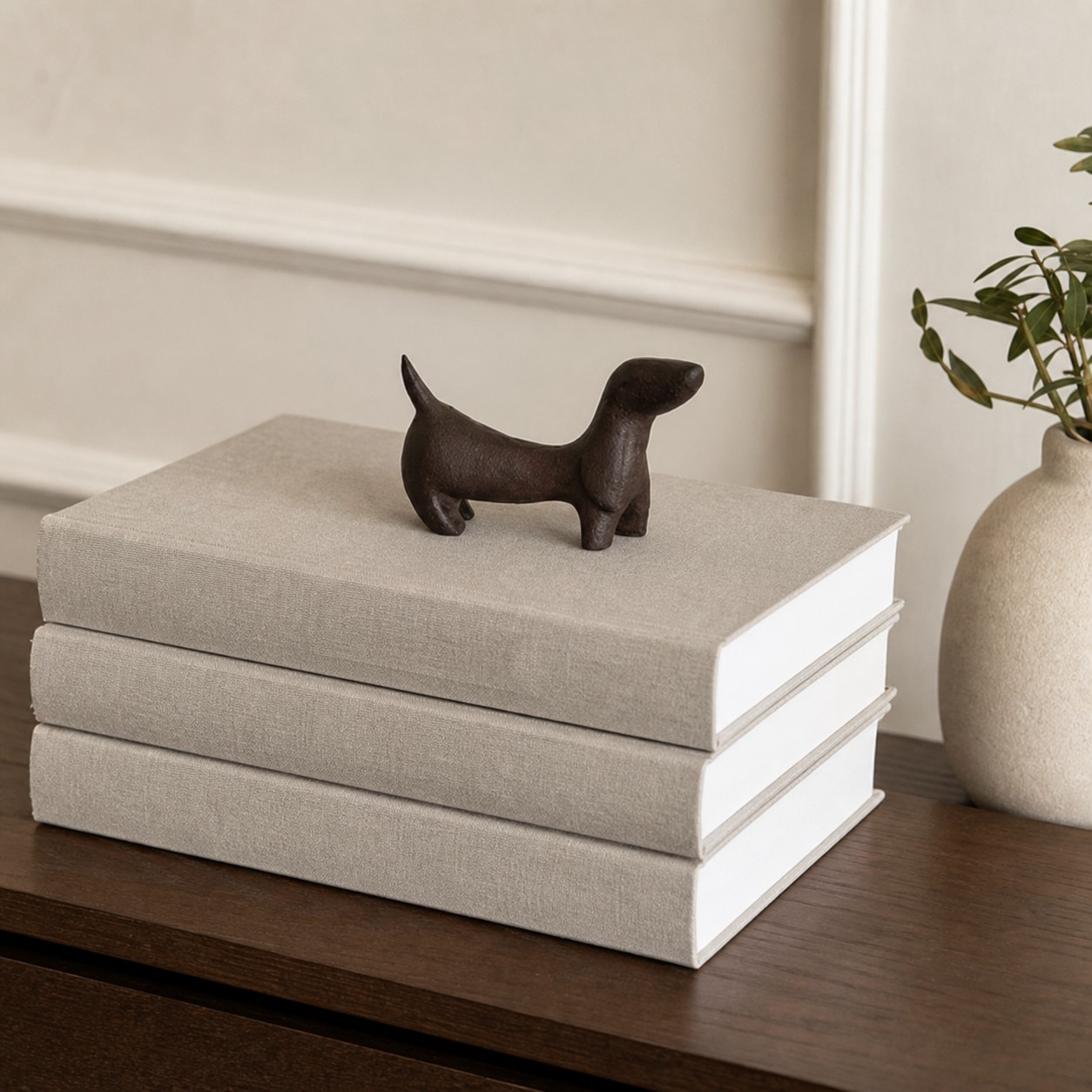 Miniature cast iron Dachshund styled on an open book