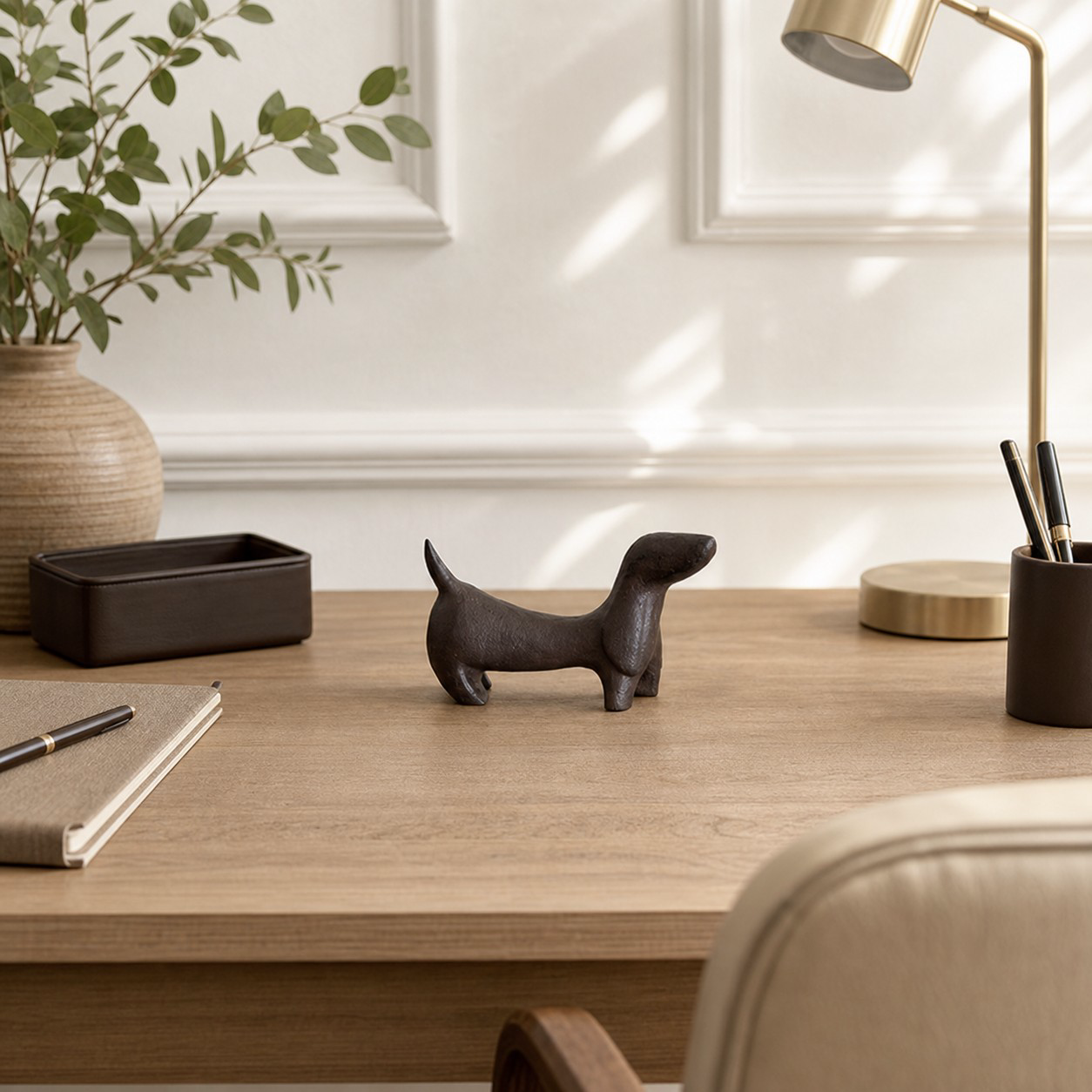 Miniature cast iron Dachshund styled on a desk