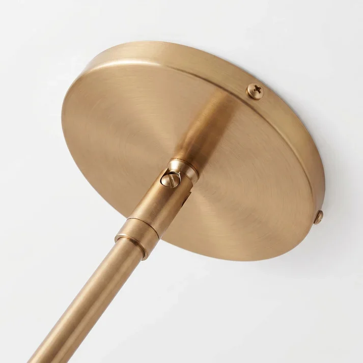 Brushed brass canopy and sloped-ceiling joint