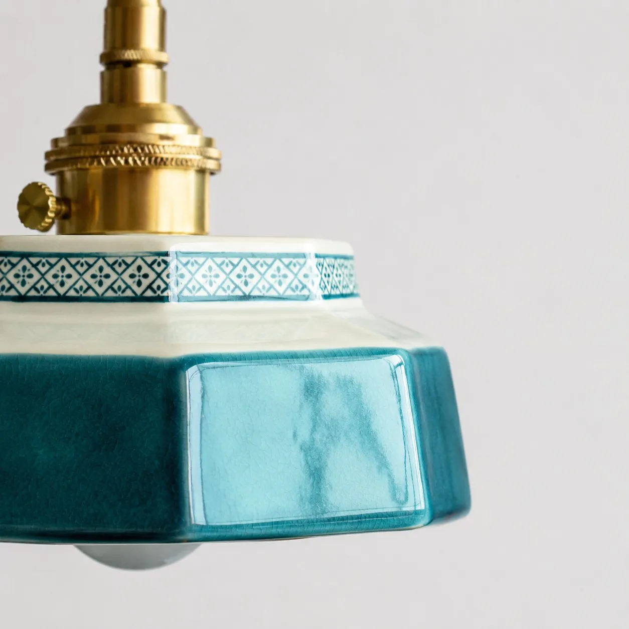 ceramic shade edge and brass hardware detail