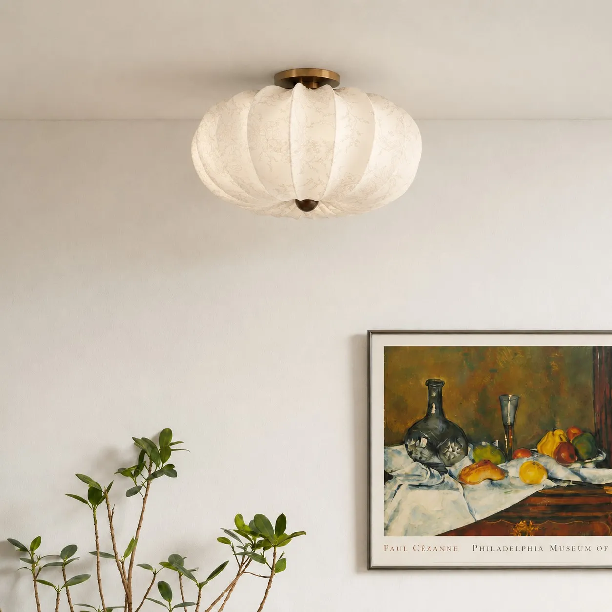 Living area scene with wall art and plant.