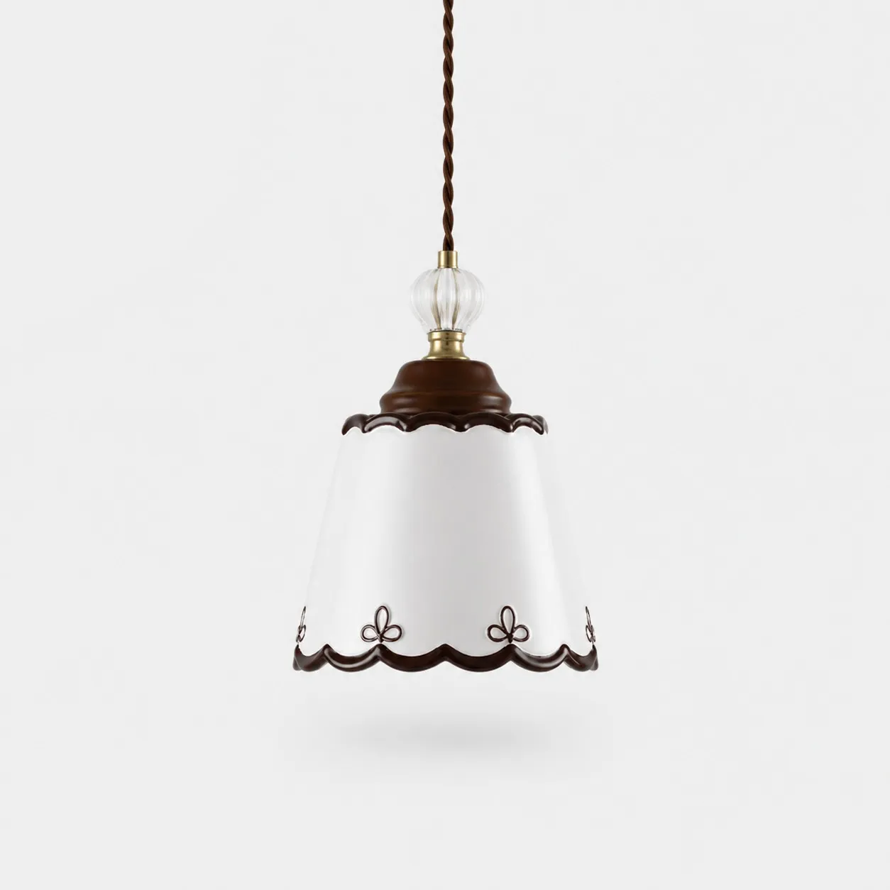 single hand-painted ceramic pendant light on a white background