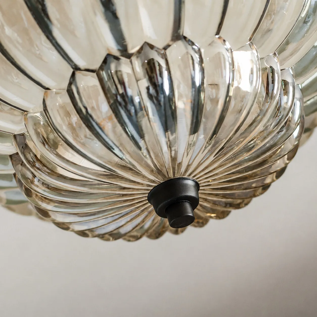 Lower glass bowl and dark finial detail
