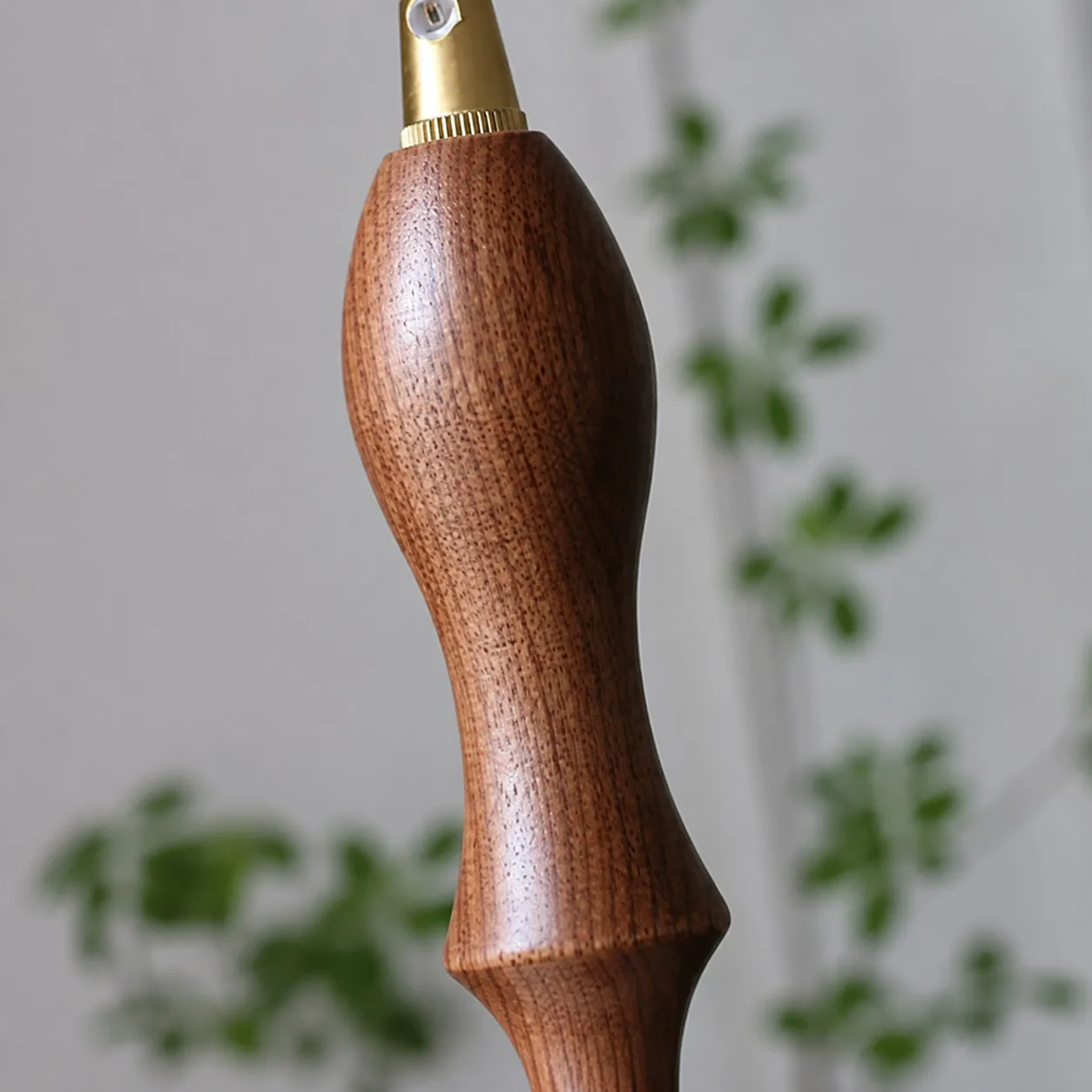 Close-up of walnut wood accent on pendant cord