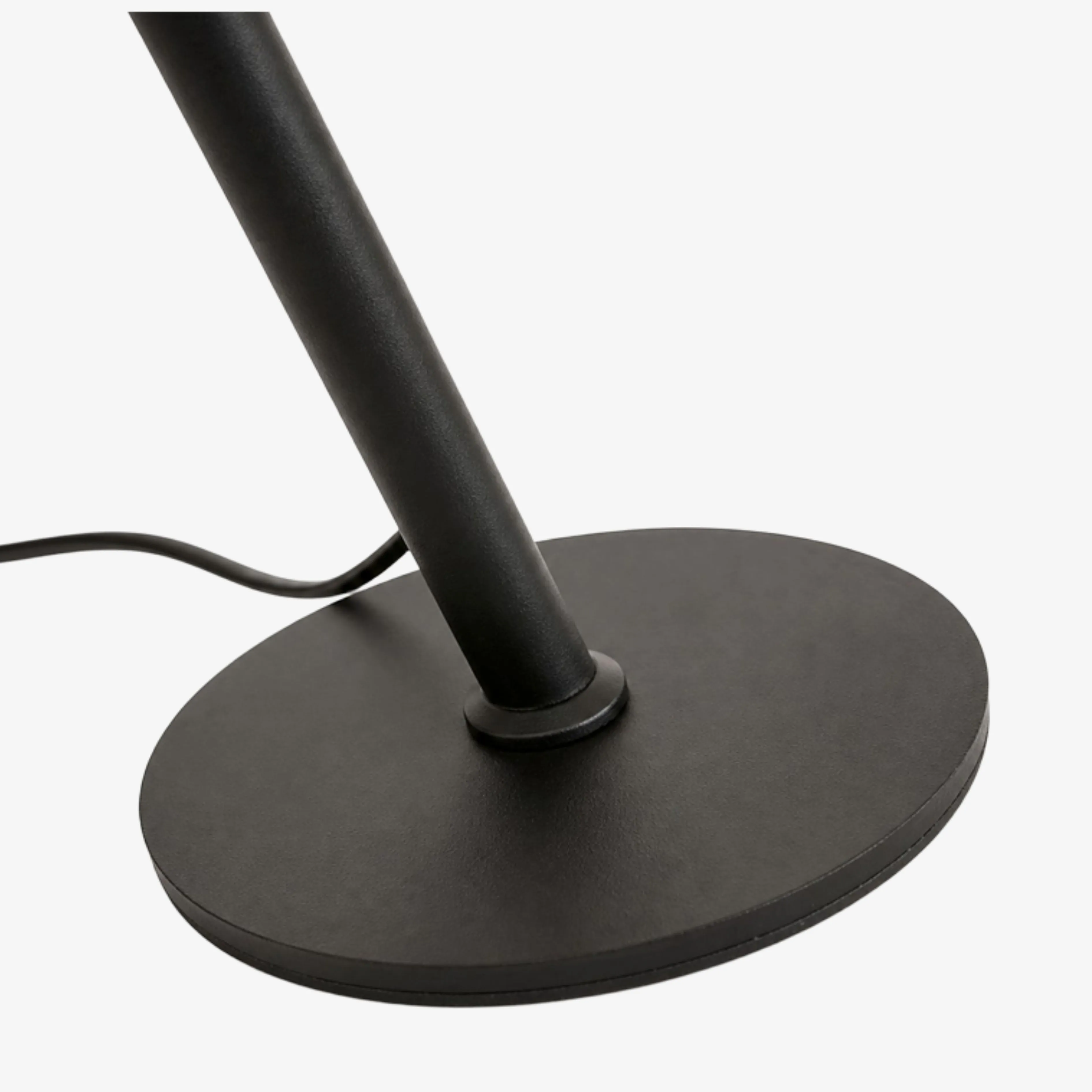 Dark metal stem and round base detail