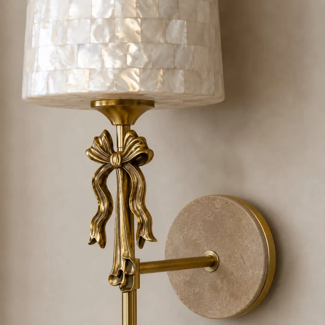 Detailed view of the shell shade, metal bow and travertine backplate