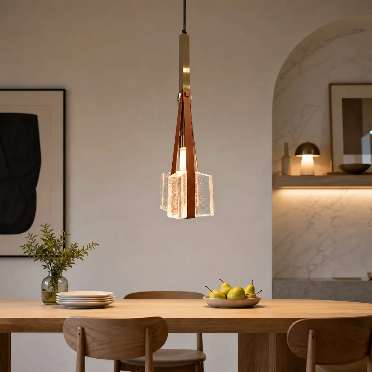 Brown leather and bubble glass pendant lamp above a dining table