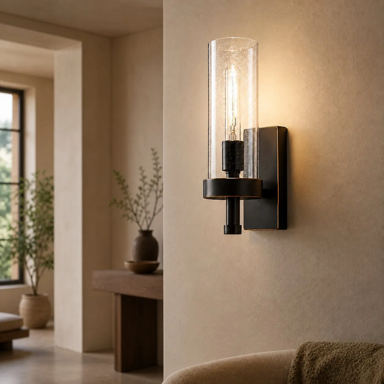 Wall sconce beside mirror and sink