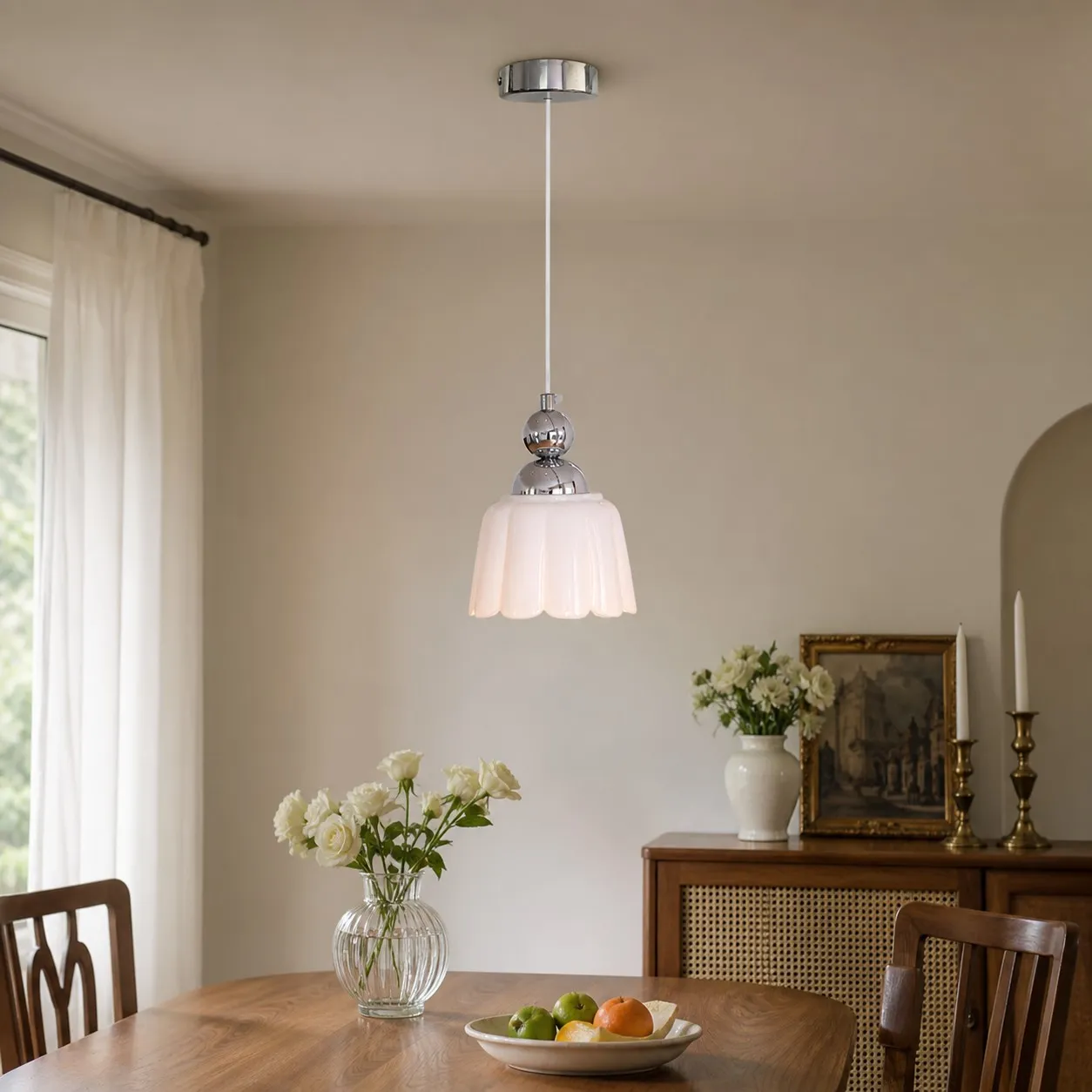 White ceramic pendant lamp above a dining table