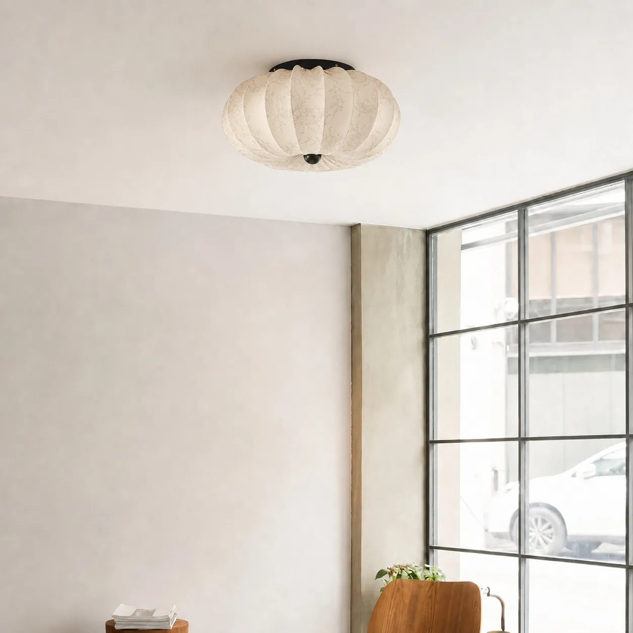 Minimal room scene near a large window.