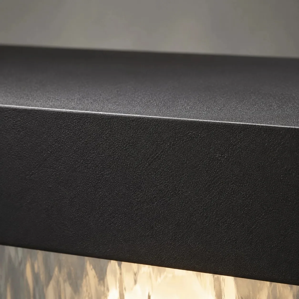 Close-up of matte black aluminum surface and upper frame edge
