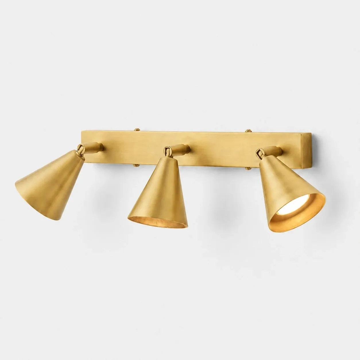 Three-head brass adjustable cone wall lamp on linear backplate
