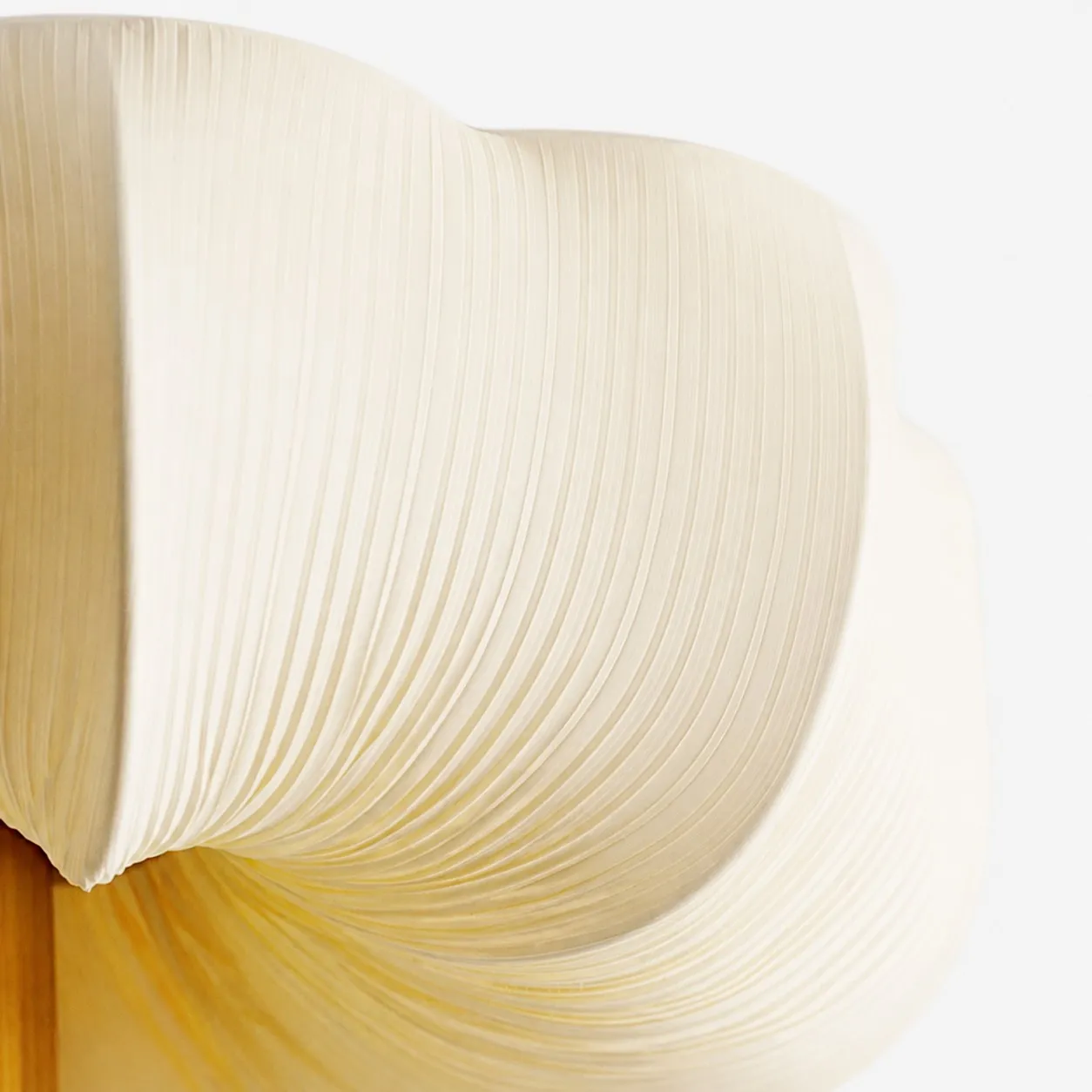 Close-up detail image showing the pleated fabric texture and soft cream shade surface.