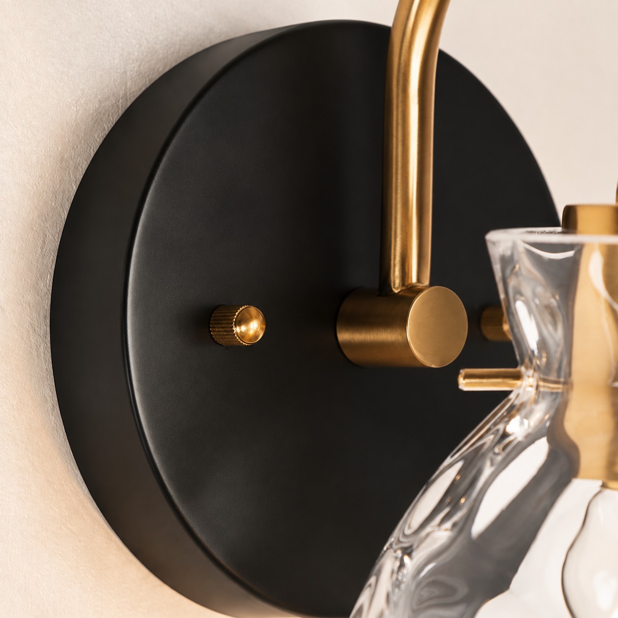 Textured Glass Wall Sconce with a clear shade and a visible bulb
