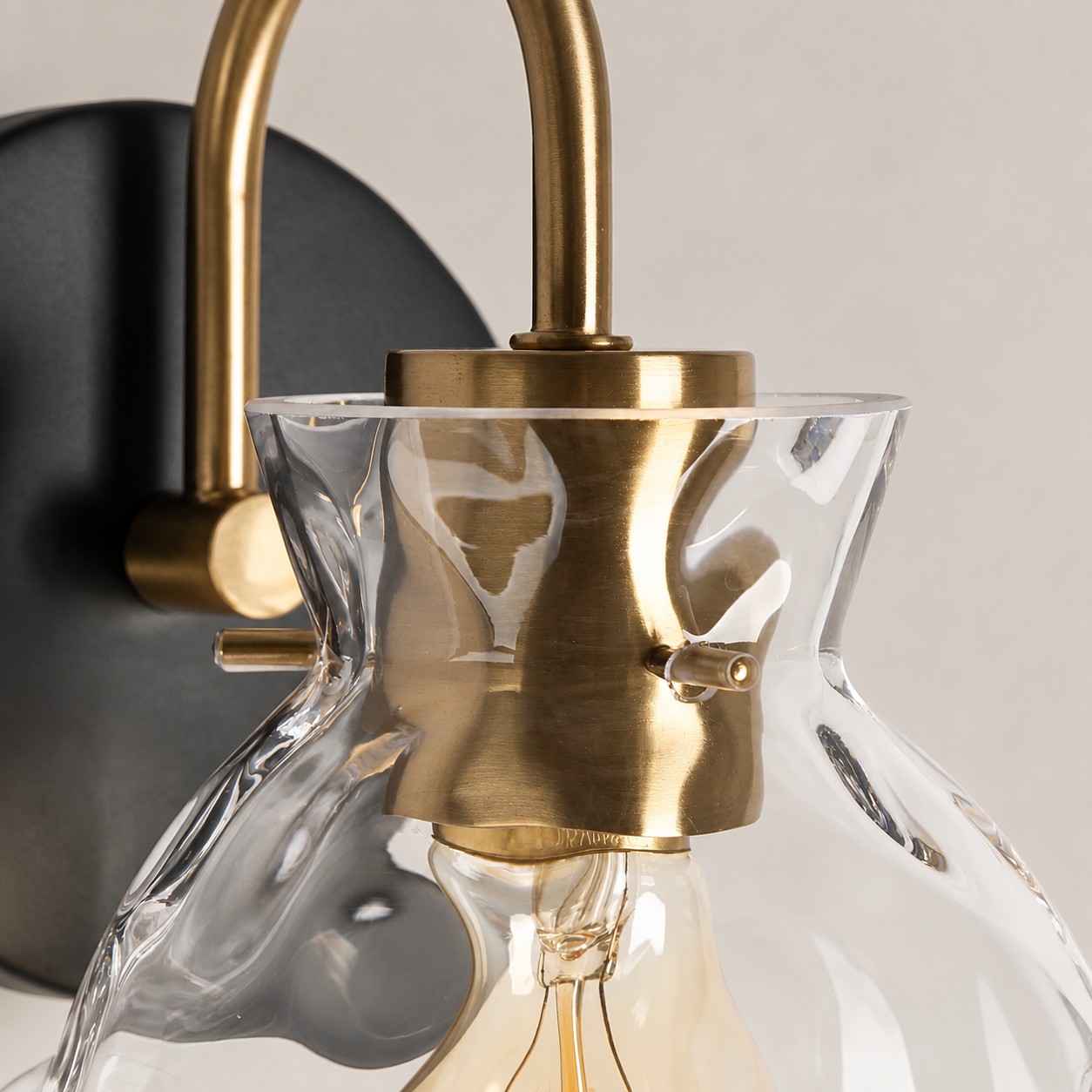 Textured Glass Wall Sconce with a clear shade and a visible bulb