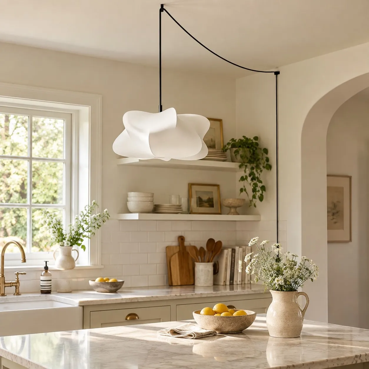 White sculptural plug-in pendant above a sunlit kitchen island