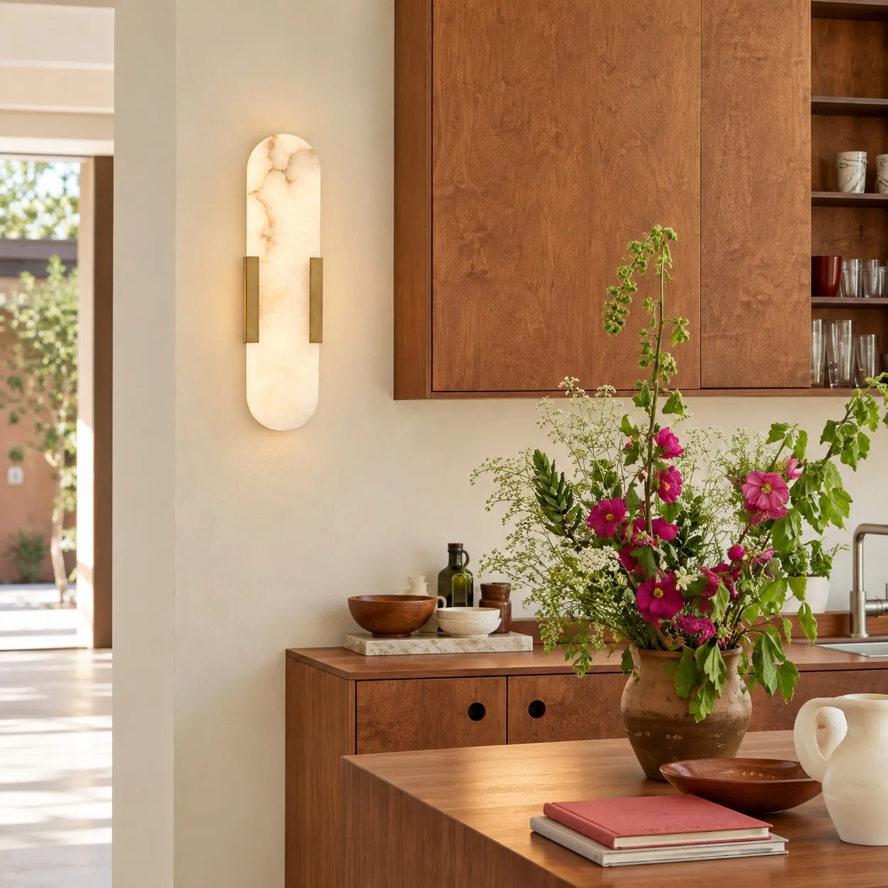 Velora brass alabaster wall light in a dining area
