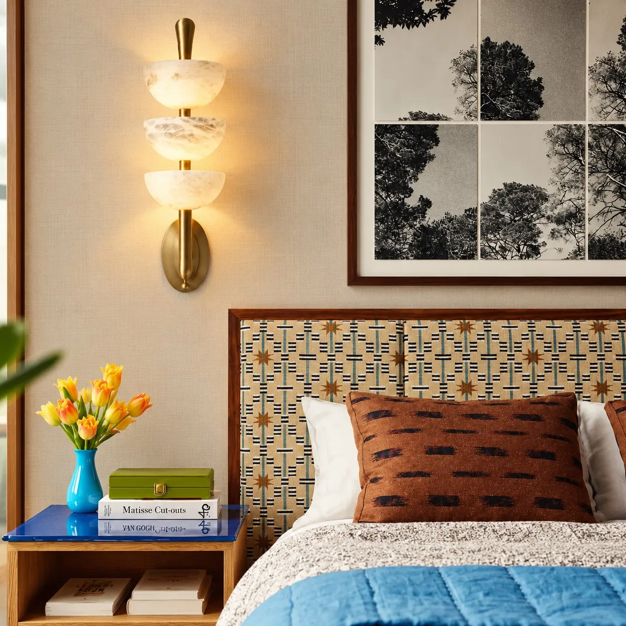 Velora alabaster wall sconce beside a bed