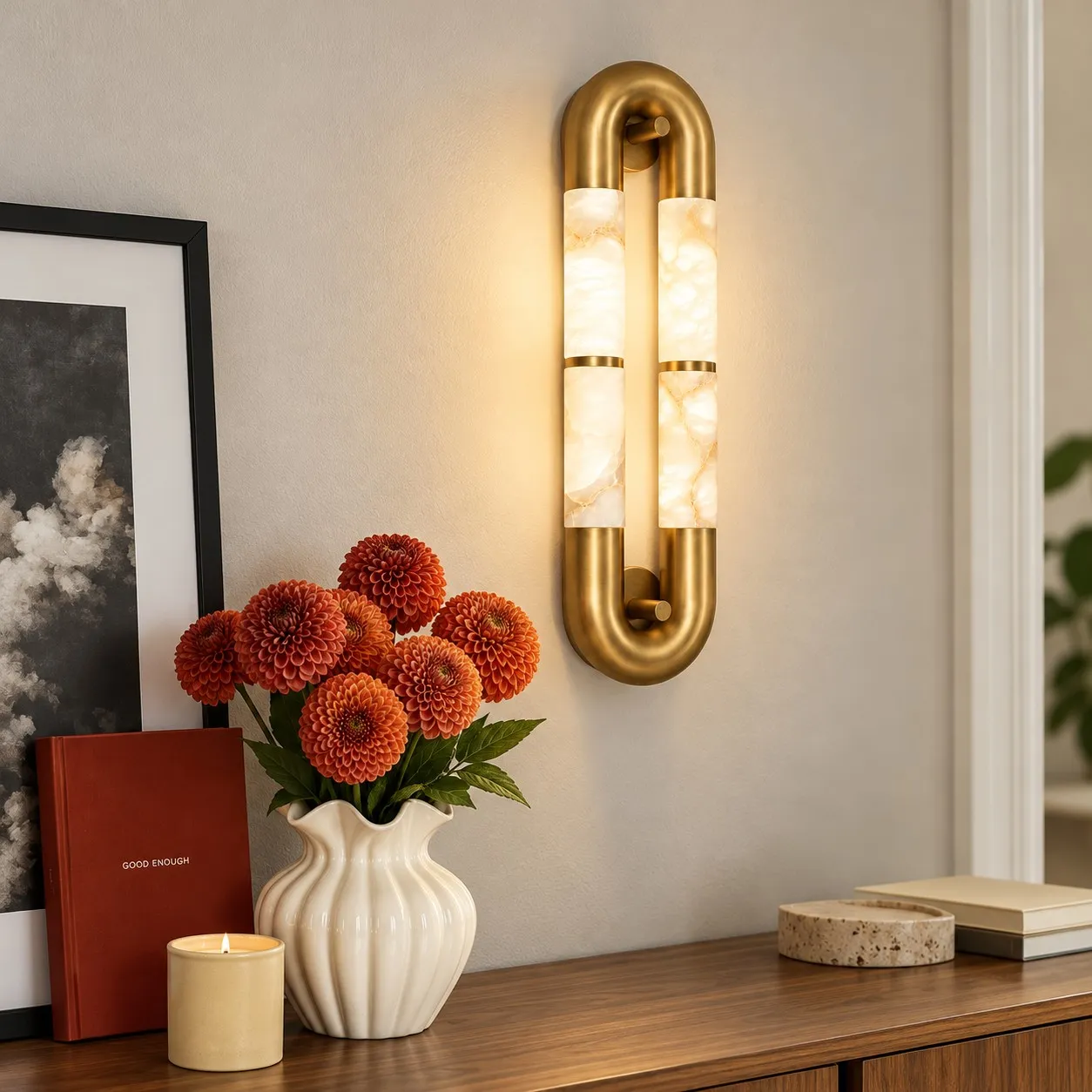 Velora alabaster wall sconce beside a console