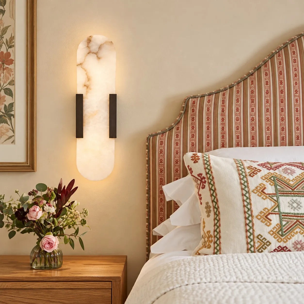 Velora black alabaster wall light beside a bed