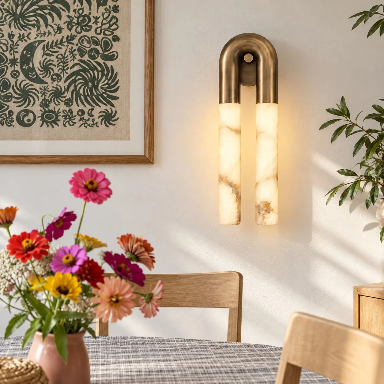 Velora brass alabaster wall light in a dining area
