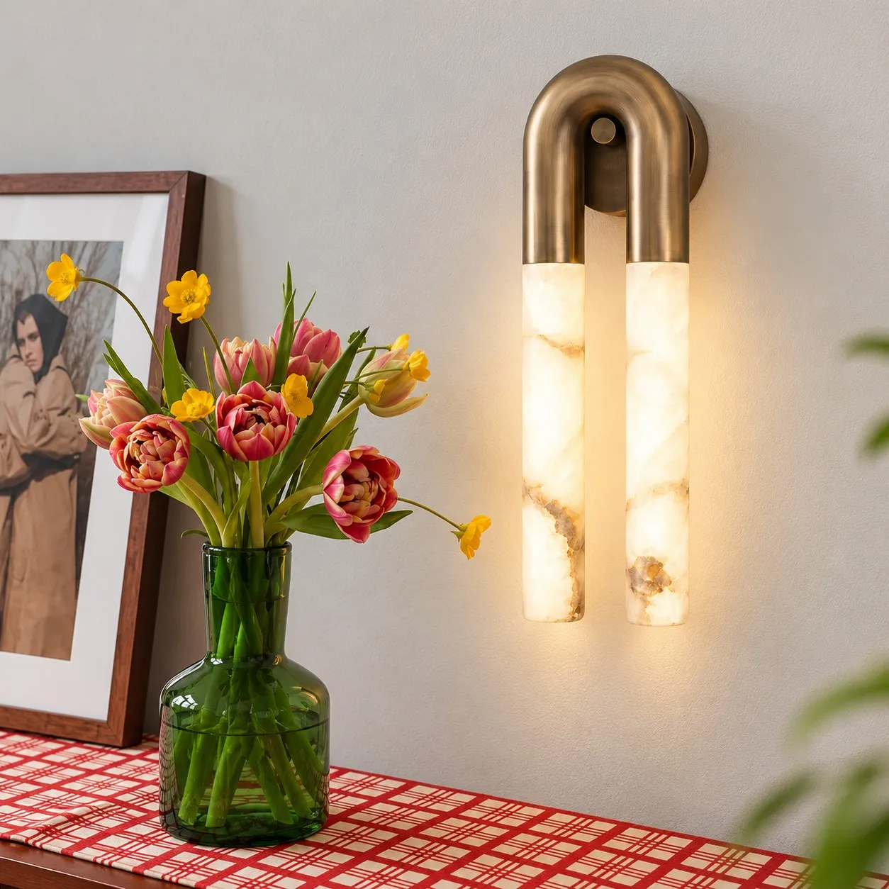 Velora bronze alabaster wall light beside flowers