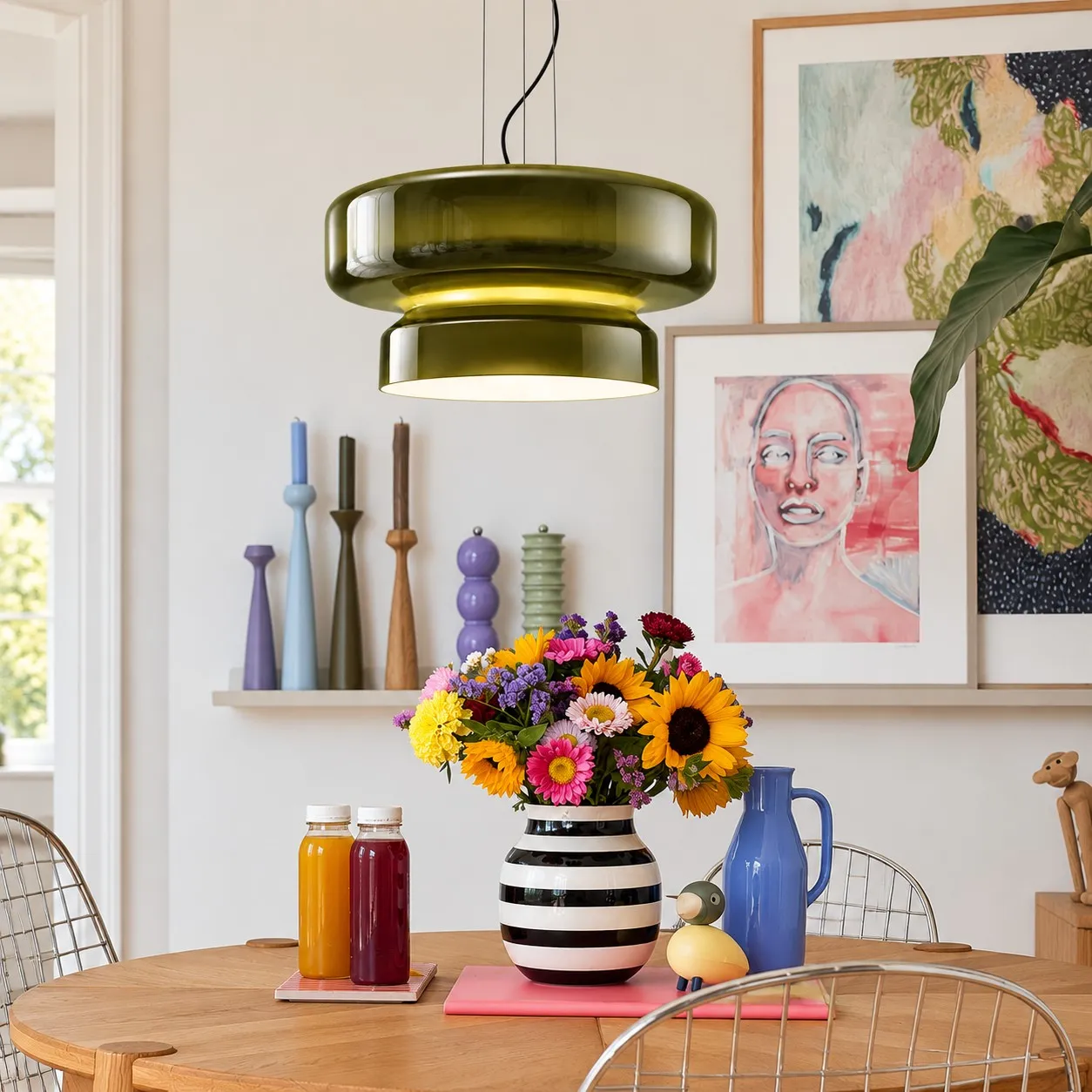 Koloro green glass pendant above a dining table