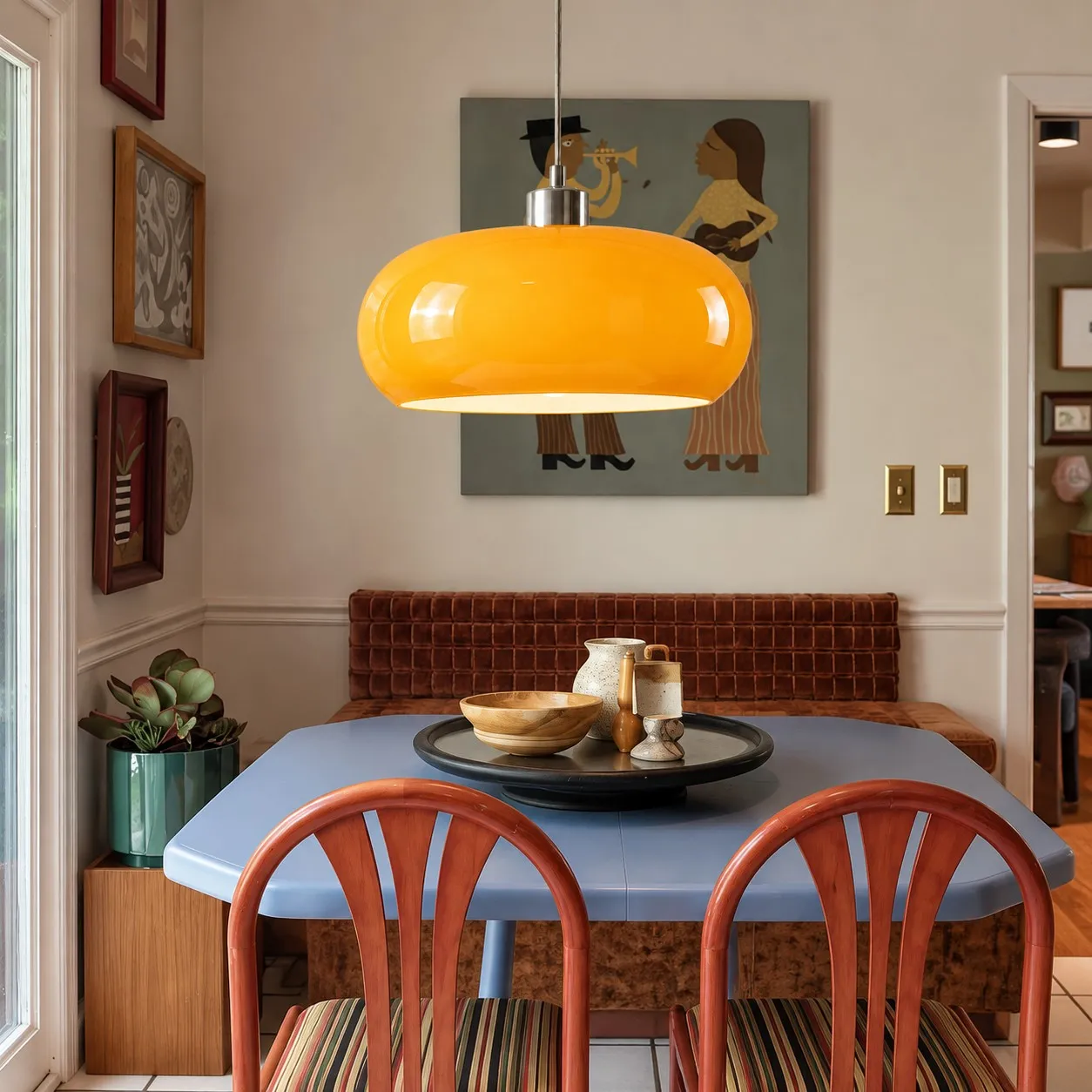 Opalora orange glass pendant above a dining table